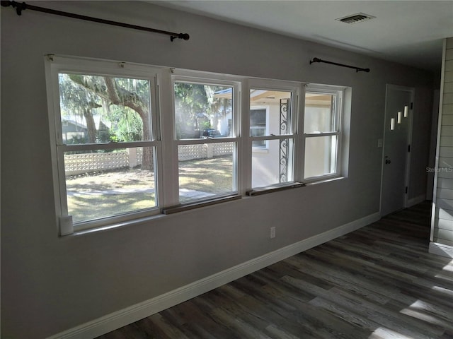 spare room with dark wood-type flooring