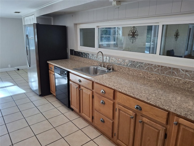 kitchen with wooden walls, sink, black dishwasher, stainless steel refrigerator, and light tile patterned flooring