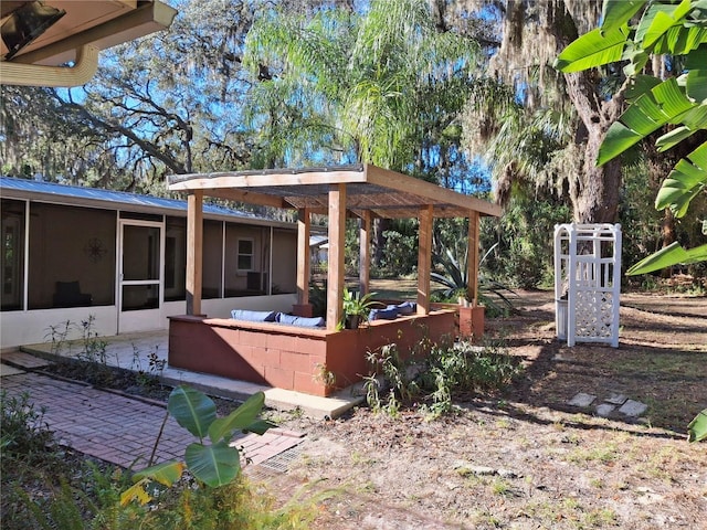 view of yard featuring a patio area and a sunroom