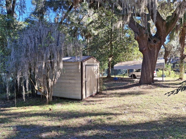 view of yard with a shed and a carport