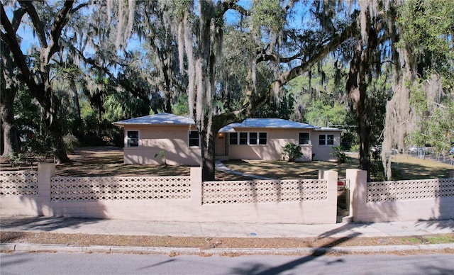 ranch-style house with a fenced front yard