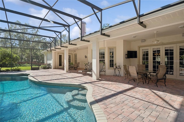 view of pool featuring french doors, ceiling fan, glass enclosure, and a patio area