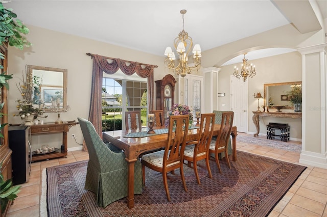 tiled dining space featuring a chandelier and ornate columns