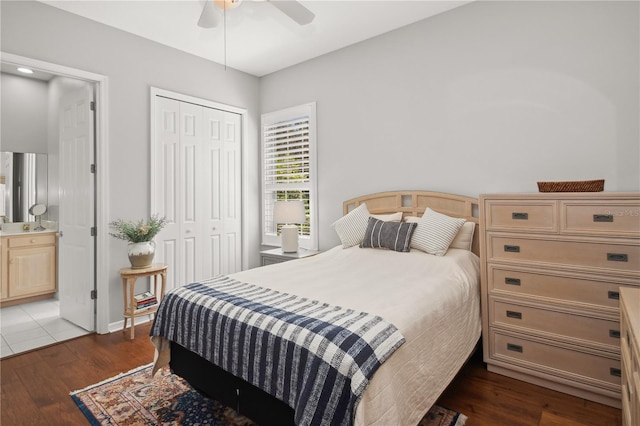 bedroom with connected bathroom, a closet, dark hardwood / wood-style floors, and ceiling fan