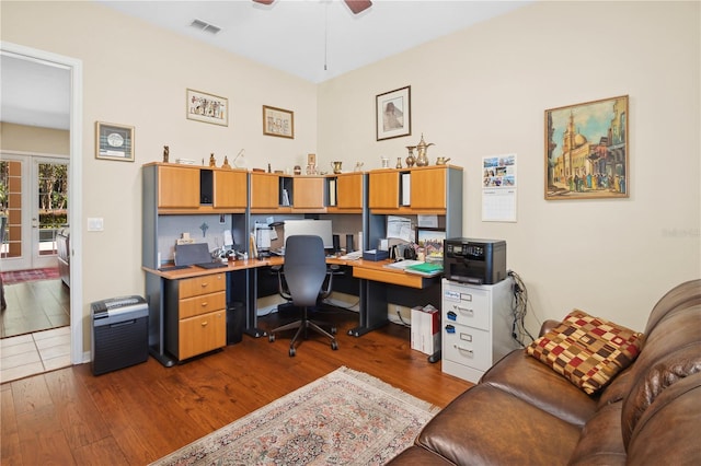 office space with ceiling fan, dark hardwood / wood-style flooring, and french doors