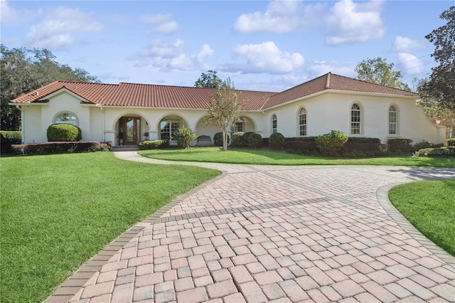 mediterranean / spanish-style home featuring a front lawn