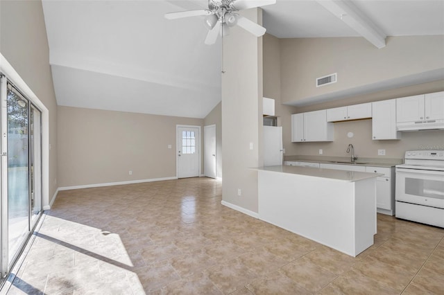 kitchen with sink, beamed ceiling, a healthy amount of sunlight, and white appliances