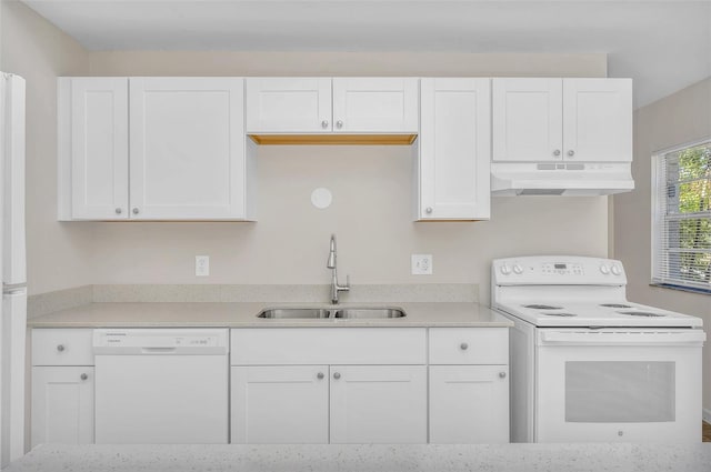 kitchen with white appliances, white cabinetry, and sink