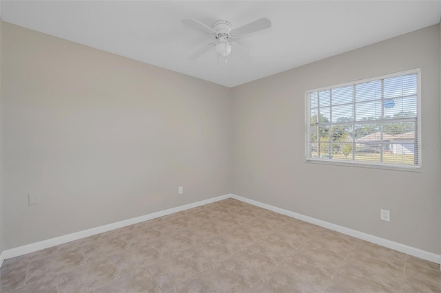 unfurnished room with ceiling fan and light tile patterned flooring