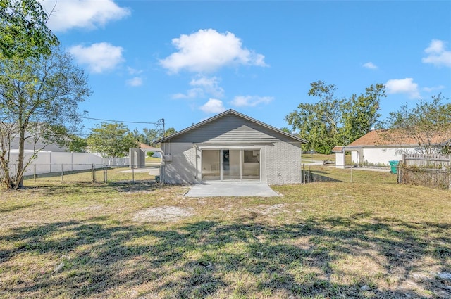 back of property featuring a lawn and a patio area