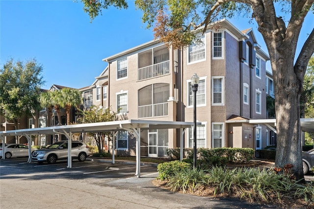7135 Yacht Basin Ave Unit 237, Orlando, FL 32835 - view of building exterior with covered parking