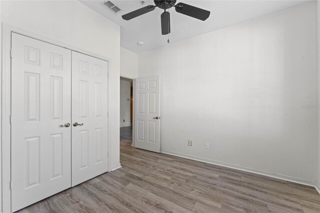 7135 Yacht Basin Ave Unit 237, Orlando, FL 32835 - unfurnished bedroom with a closet, wood finished floors, baseboards, and ceiling fan