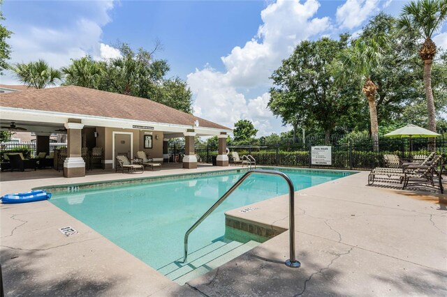 7135 Yacht Basin Ave Unit 237, Orlando, FL 32835 - community pool with a patio and a ceiling fan