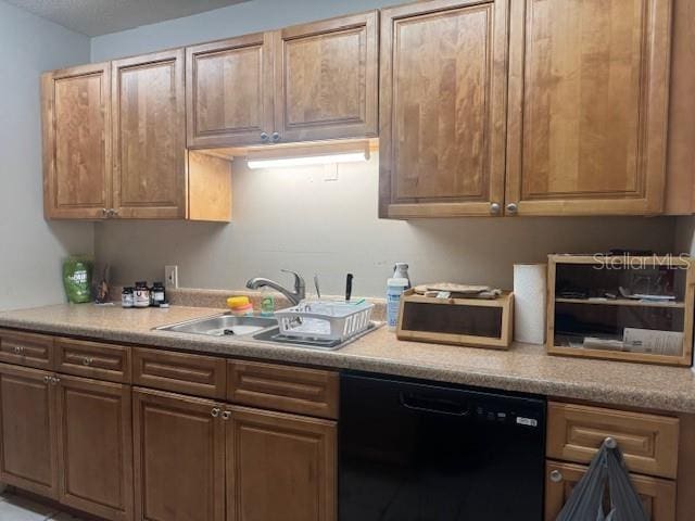 kitchen featuring sink and black dishwasher