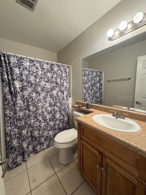 bathroom featuring tile patterned flooring, vanity, and toilet