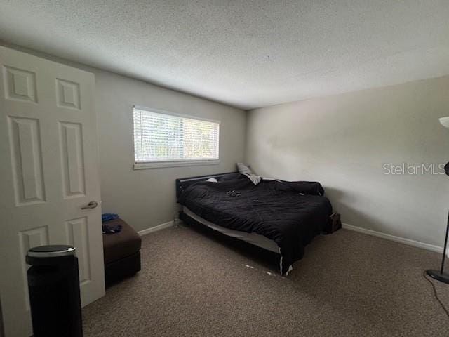 bedroom with carpet and a textured ceiling