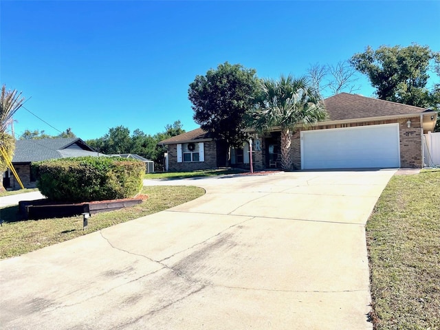 single story home with a garage and a front lawn