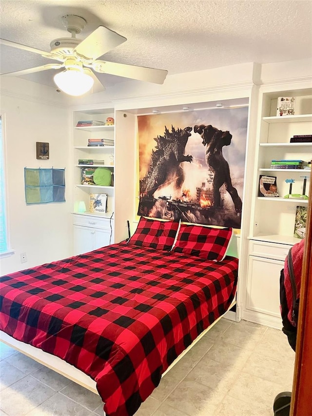 bedroom with a textured ceiling and ceiling fan