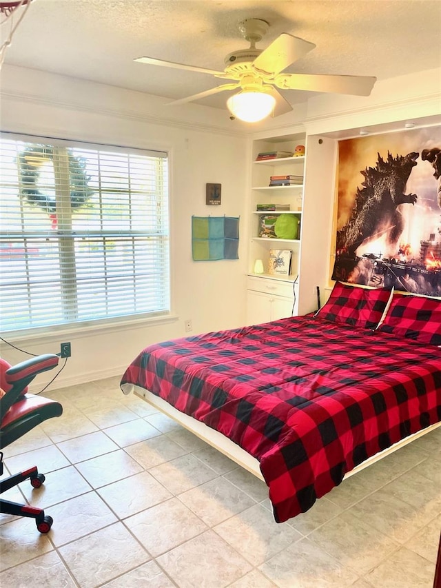 tiled bedroom featuring ceiling fan and a textured ceiling