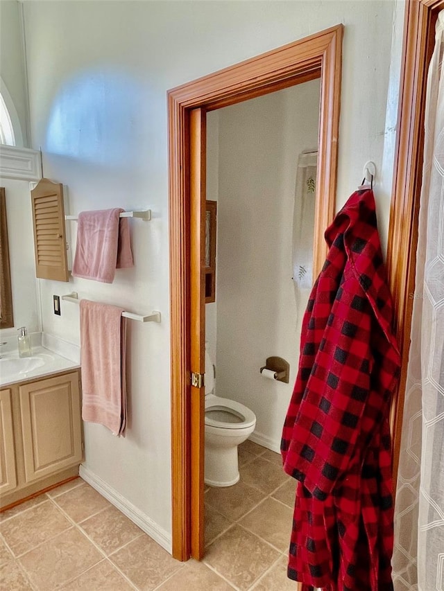 bathroom featuring toilet, vanity, and tile patterned floors