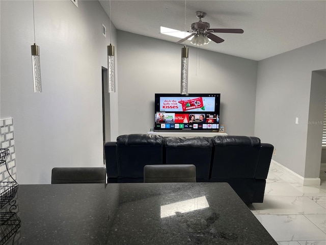 living room with a textured ceiling, vaulted ceiling, and ceiling fan