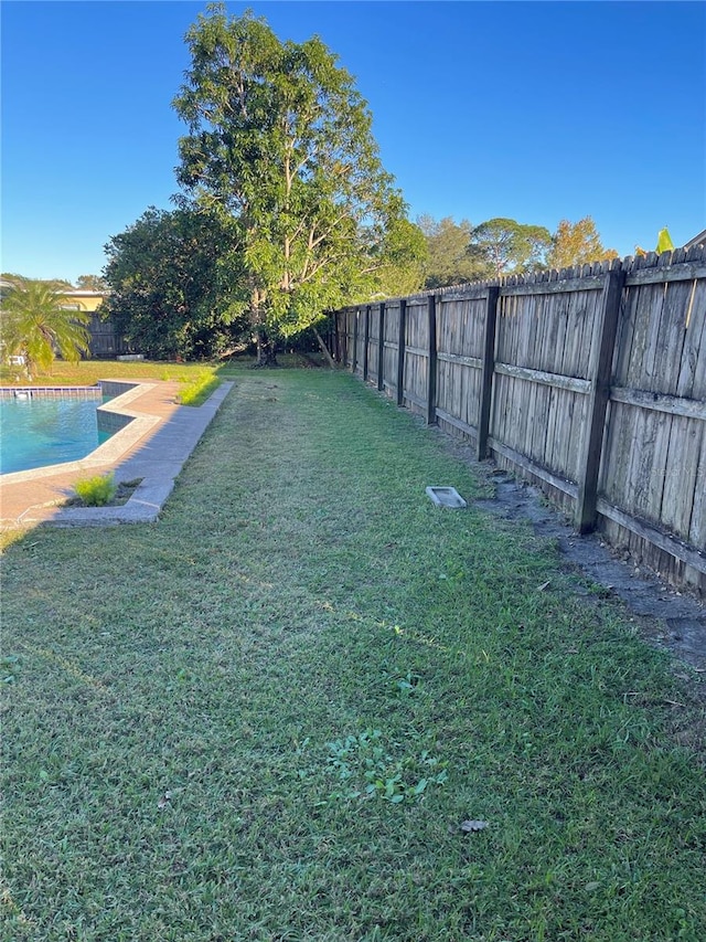 view of yard with a fenced in pool