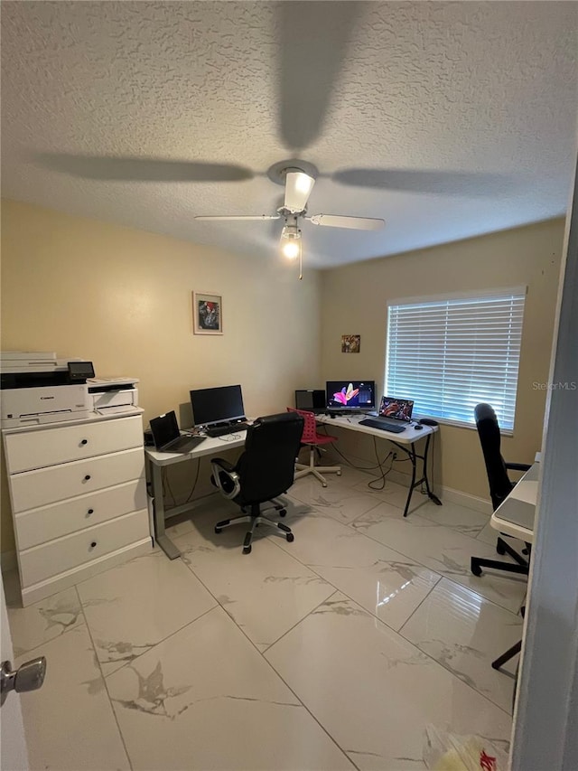 office featuring a textured ceiling and ceiling fan