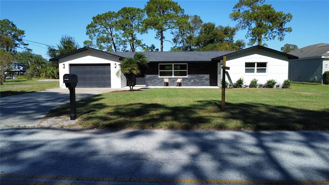 ranch-style home featuring a front lawn and a garage