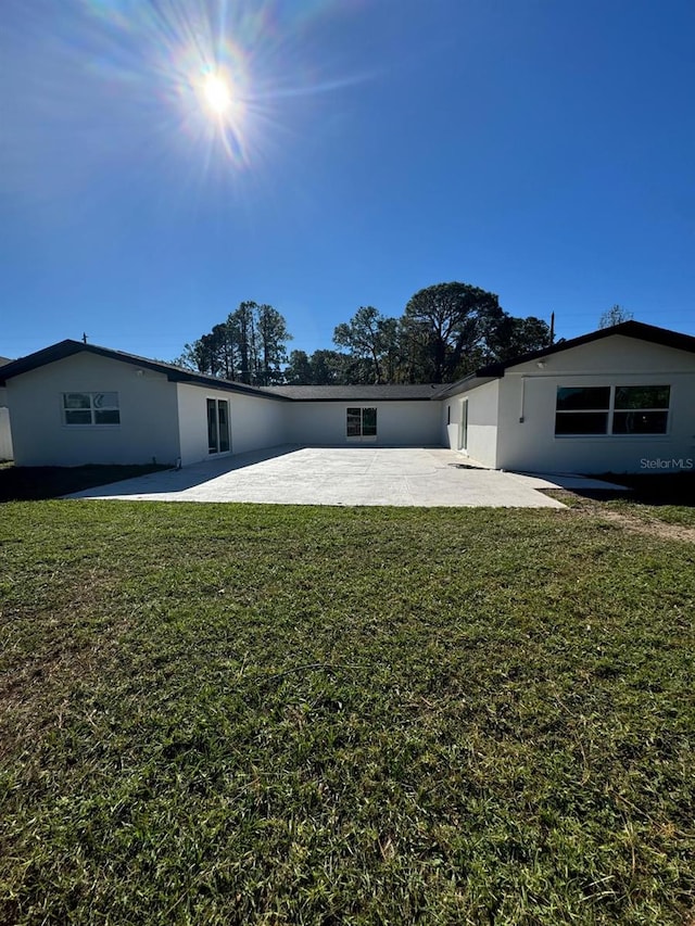 rear view of house with a patio area and a yard