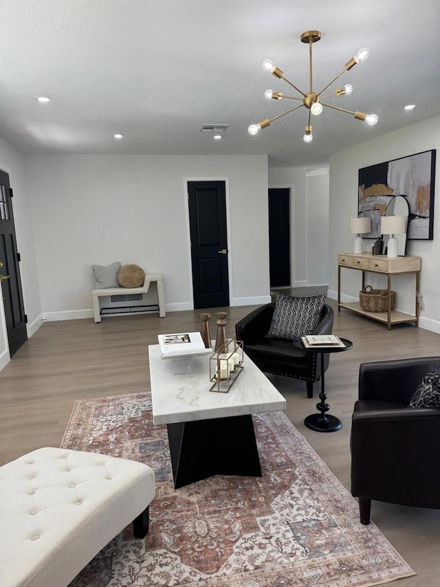 living room featuring light hardwood / wood-style floors and an inviting chandelier