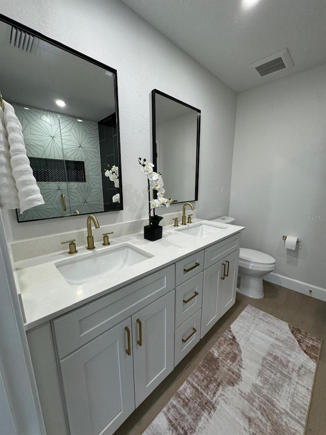 bathroom with vanity, hardwood / wood-style flooring, toilet, and an enclosed shower