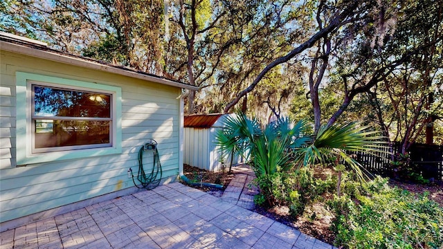 view of patio featuring a storage shed