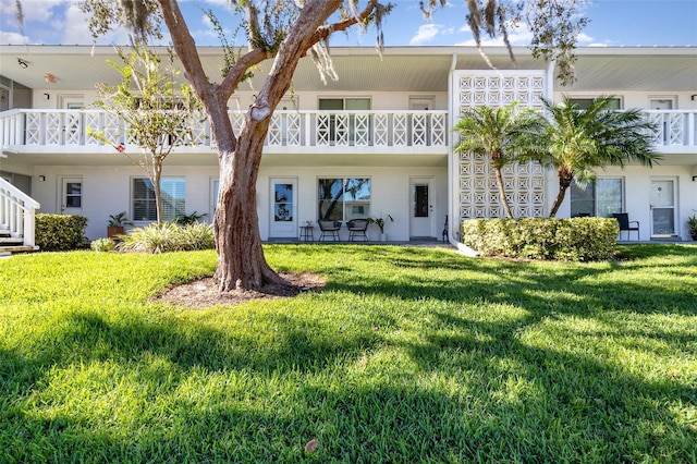 rear view of house with a yard