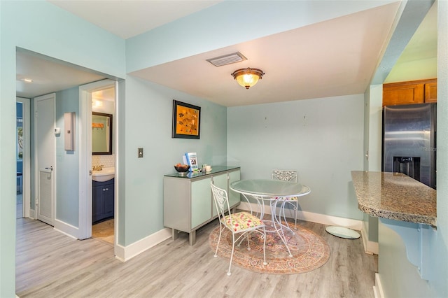 dining room featuring light hardwood / wood-style floors and sink