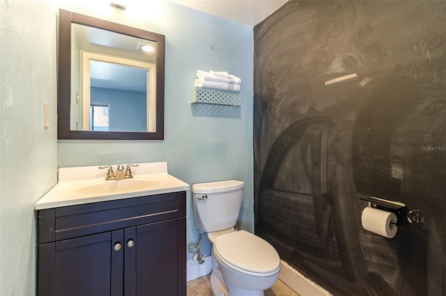 bathroom featuring tile patterned flooring, vanity, and toilet