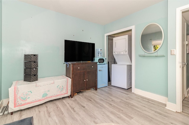 interior space featuring stacked washer and dryer and light wood-type flooring