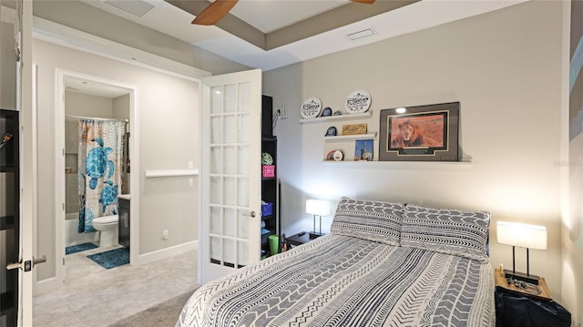 carpeted bedroom featuring ensuite bathroom and ceiling fan