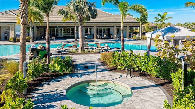 view of pool featuring a patio area and a community hot tub