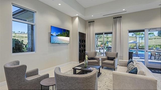 tiled living room featuring a high ceiling