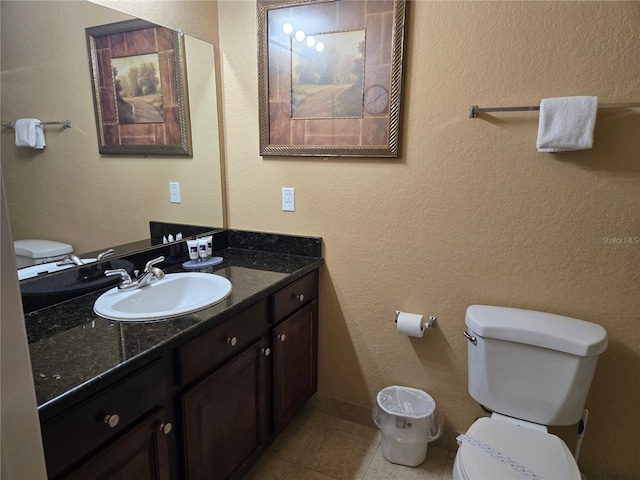 bathroom with tile patterned floors, vanity, and toilet