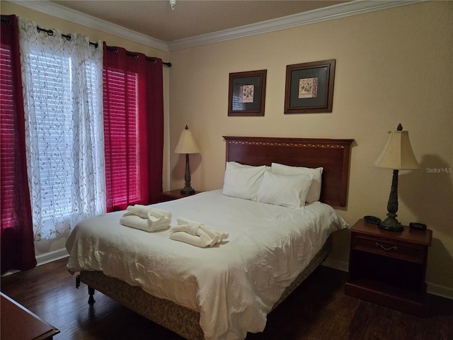 bedroom with dark hardwood / wood-style floors and ornamental molding