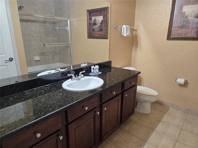 full bathroom with tile patterned flooring, vanity, toilet, and combined bath / shower with glass door