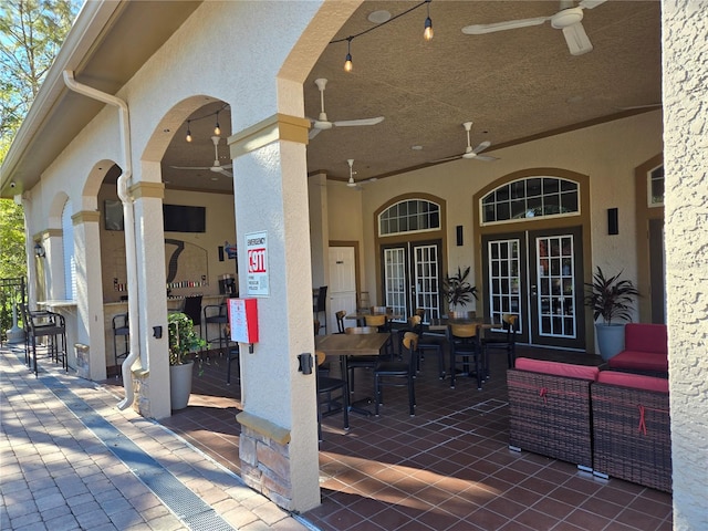 view of patio / terrace featuring an outdoor living space, an outdoor bar, and ceiling fan