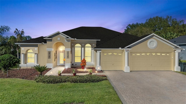 view of front of property with a yard and a garage