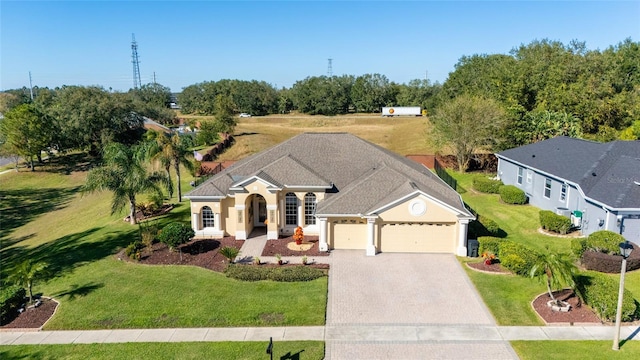 ranch-style house with a front yard and a garage