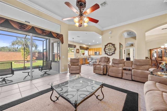 tiled living room featuring ceiling fan and ornamental molding