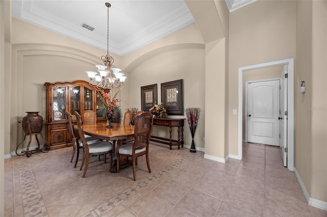 dining area featuring light tile patterned flooring, crown molding, and a chandelier