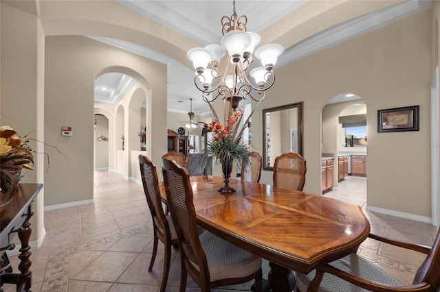 tiled dining space featuring crown molding and a chandelier