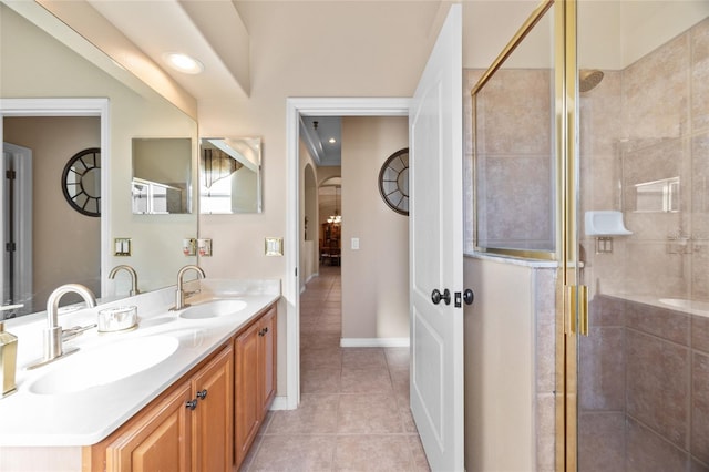 bathroom featuring tile patterned flooring, vanity, and an enclosed shower