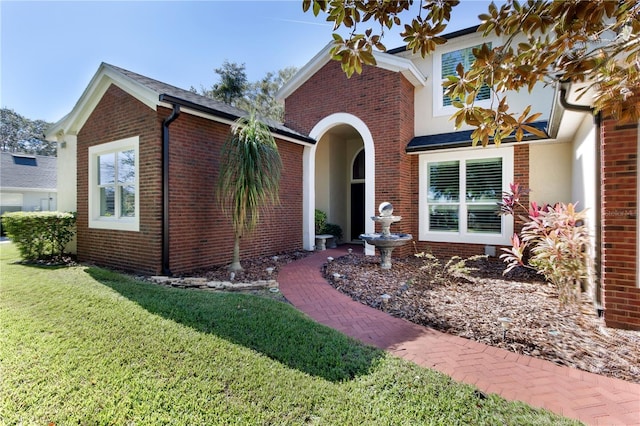 traditional home featuring brick siding and a front yard